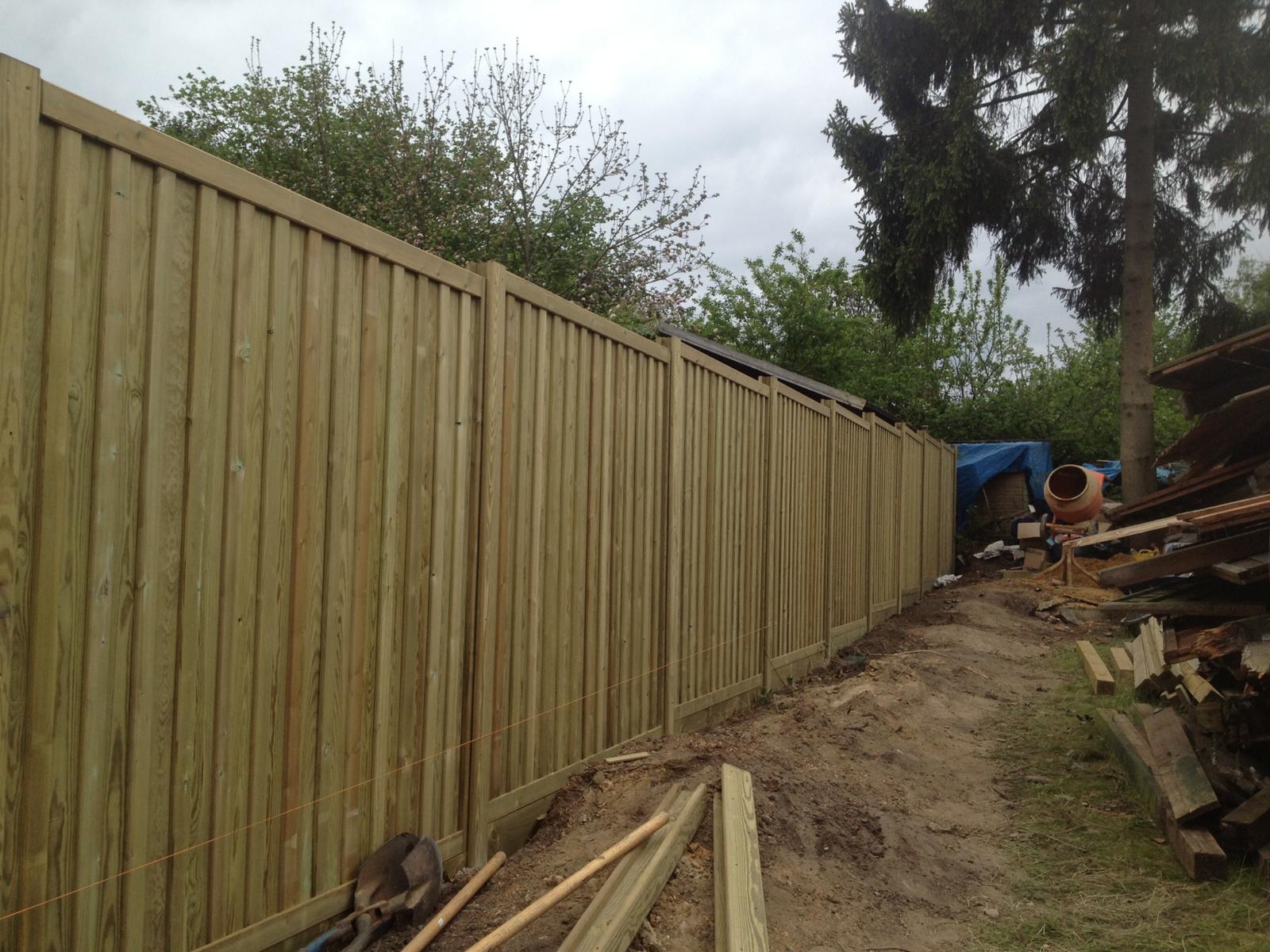 Long run of close-board fencing under construction